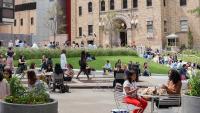 Columbia Mailman Campus, students sitting outside in Haven Plaza in front of the Allan Rosenfeld Building.